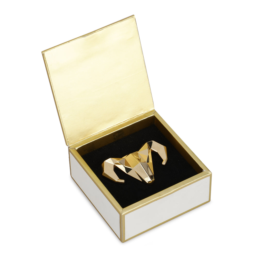 Closed ivory Dusala heritage gift box with lotus artwork, rider illustration, gold handle, and clasp detail.